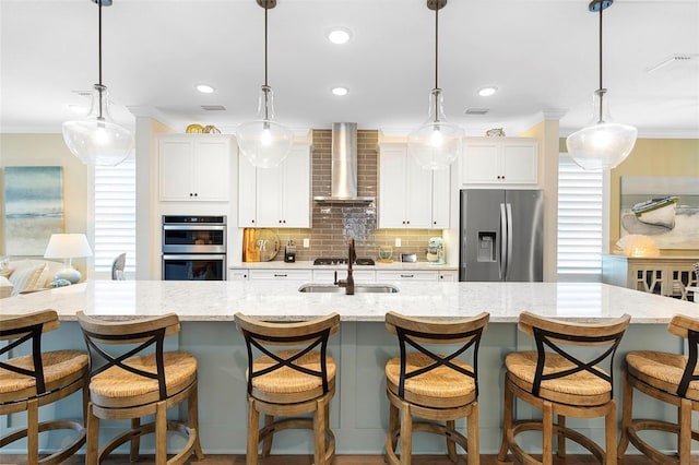 249 Kellet Way, Saint Johns, FL 32259 - kitchen featuring appliances with stainless steel finishes, ornamental molding, white cabinetry, tasteful backsplash, and wall chimney range hood