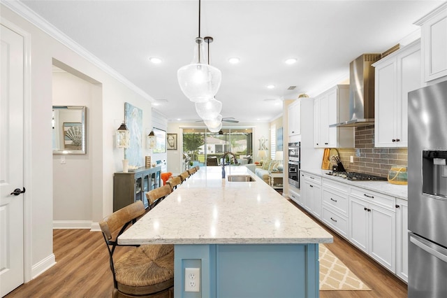 249 Kellet Way, Saint Johns, FL 32259 - kitchen with crown molding, stainless steel appliances, a kitchen bar, light wood-type flooring, and tasteful backsplash