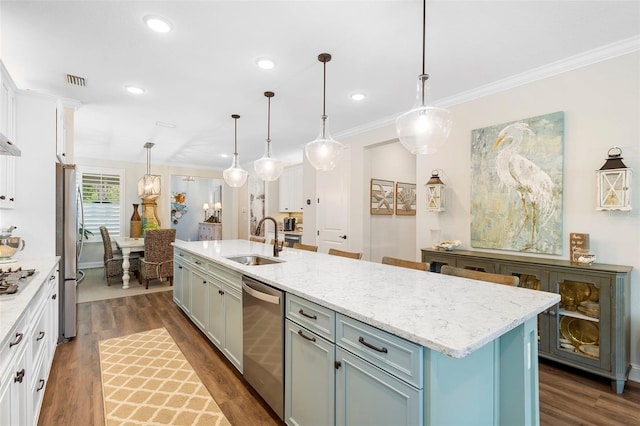 249 Kellet Way, Saint Johns, FL 32259 - kitchen featuring appliances with stainless steel finishes, dark wood-style floors, an island with sink, crown molding, and white cabinets