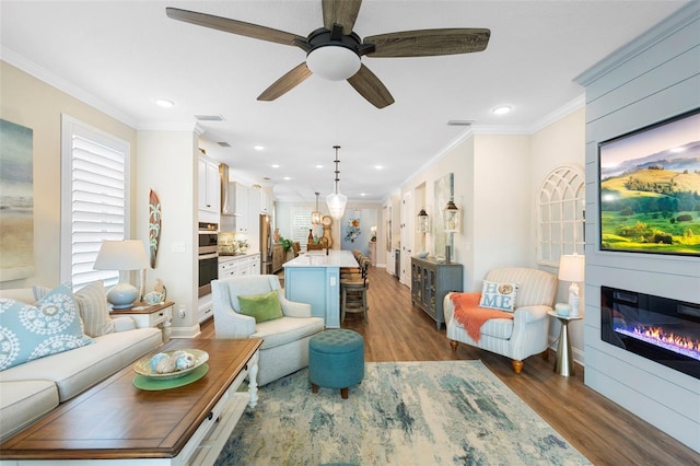 249 Kellet Way, Saint Johns, FL 32259 - living room featuring wood finished floors, recessed lighting, a glass covered fireplace, ornamental molding, and ceiling fan