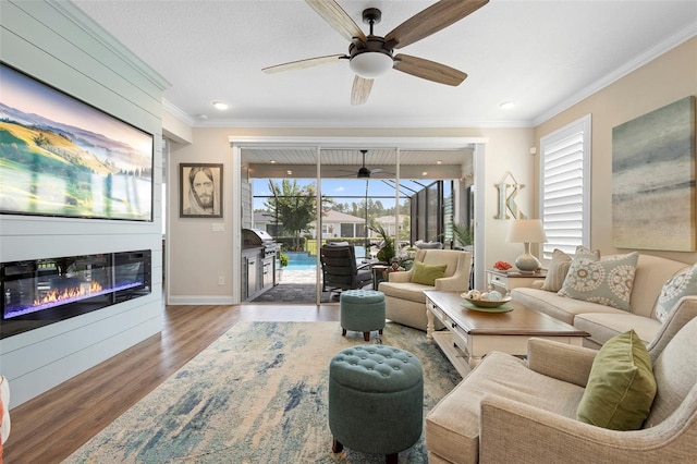 249 Kellet Way, Saint Johns, FL 32259 - living area featuring crown molding, wood finished floors, a glass covered fireplace, and ceiling fan