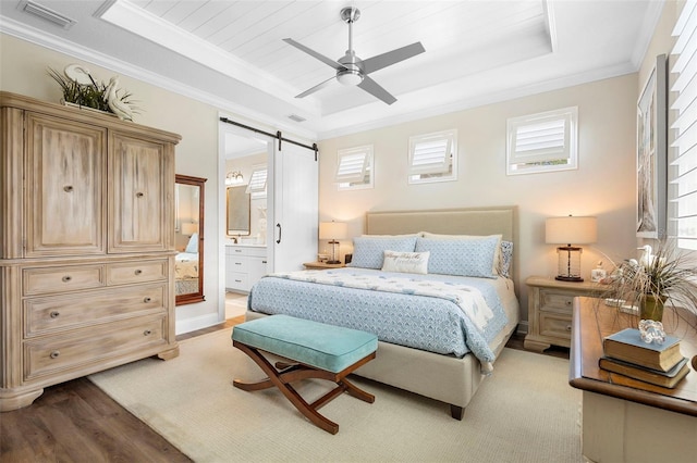 249 Kellet Way, Saint Johns, FL 32259 - bedroom featuring a tray ceiling, a barn door, multiple windows, crown molding, and wood finished floors