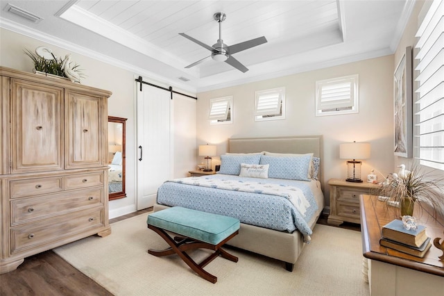 249 Kellet Way, Saint Johns, FL 32259 - bedroom with a raised ceiling, a barn door, multiple windows, crown molding, and light wood-type flooring