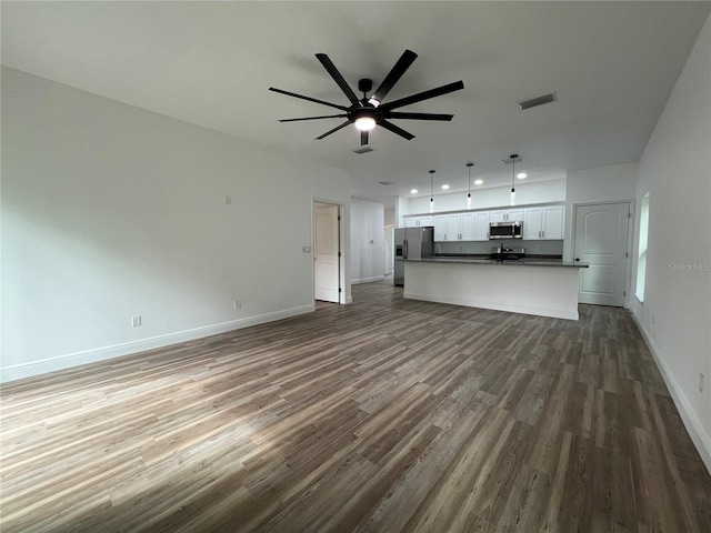 1510 Granada Ave, Daytona Beach, FL 32117 - unfurnished living room with dark wood-style flooring, ceiling fan, and recessed lighting