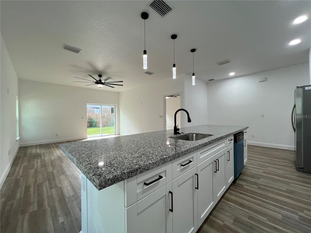 1510 Granada Ave, Daytona Beach, FL 32117 - kitchen with wood finished floors, freestanding refrigerator, open floor plan, white cabinetry, and a ceiling fan