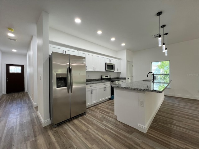 1510 Granada Ave, Daytona Beach, FL 32117 - kitchen with appliances with stainless steel finishes, dark wood-type flooring, white cabinetry, pendant lighting, and recessed lighting