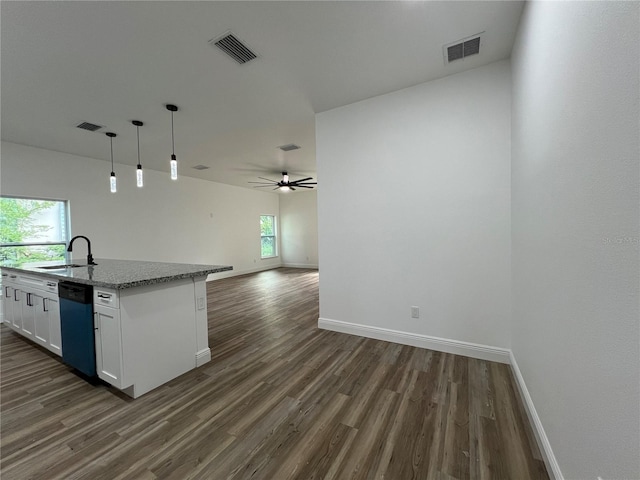1510 Granada Ave, Daytona Beach, FL 32117 - kitchen with open floor plan, dark wood-style flooring, plenty of natural light, and white cabinetry