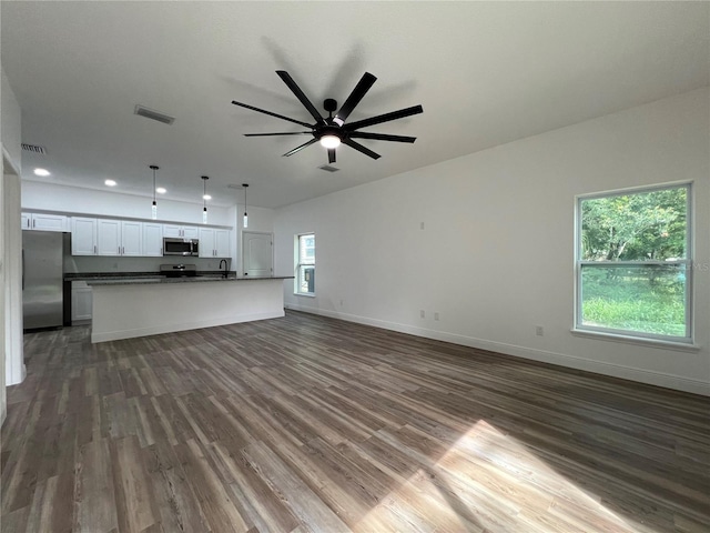 1510 Granada Ave, Daytona Beach, FL 32117 - unfurnished living room featuring dark wood-style flooring, ceiling fan, and recessed lighting