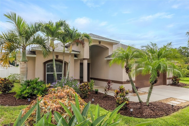 6151 Sabal Point Cir, Port Orange, FL 32128 - mediterranean / spanish-style house with stucco siding, concrete driveway, and an attached garage