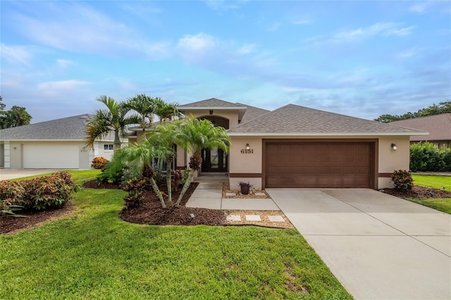 6151 Sabal Point Cir, Port Orange, FL 32128 - view of front of house featuring stucco siding, driveway, an attached garage, and a front yard