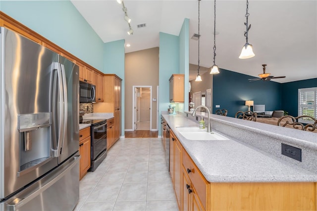 6151 Sabal Point Cir, Port Orange, FL 32128 - kitchen featuring stainless steel refrigerator with ice dispenser, black microwave, double oven range, a peninsula, and track lighting