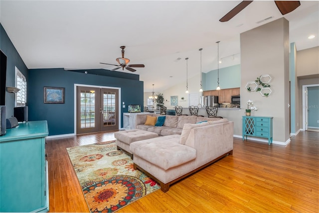 6151 Sabal Point Cir, Port Orange, FL 32128 - living area with a ceiling fan, vaulted ceiling, and light wood-style flooring