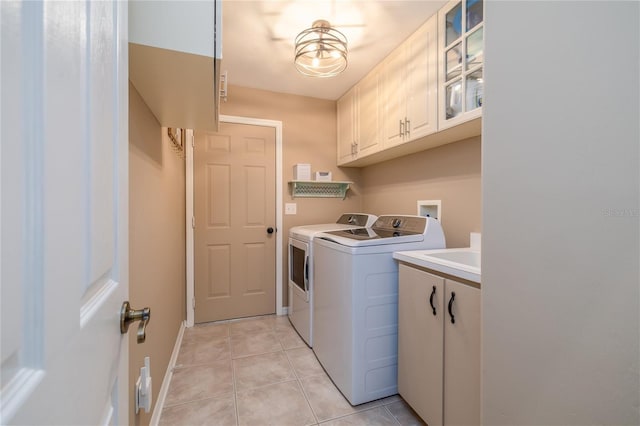 6151 Sabal Point Cir, Port Orange, FL 32128 - laundry area with cabinet space, washing machine and clothes dryer, and light tile patterned floors