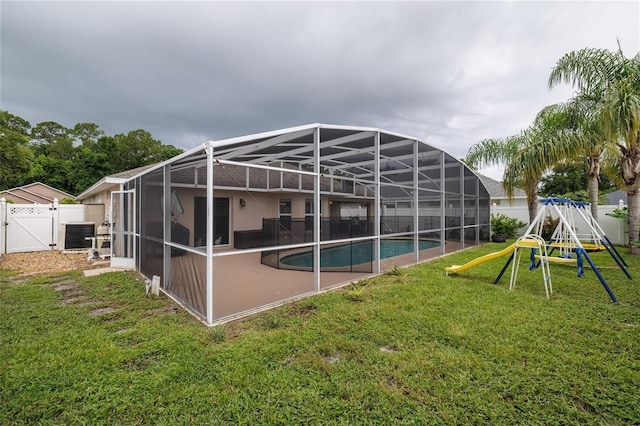 6151 Sabal Point Cir, Port Orange, FL 32128 - rear view of house with a gate, a fenced backyard, a playground, a lanai, and a patio area