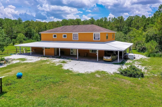 4666 Fir Rd, New Smyrna Beach, FL 32168 - view of front facade featuring a carport, a forest view, driveway, and a metal roof