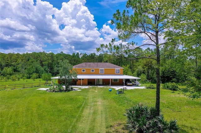 4666 Fir Rd, New Smyrna Beach, FL 32168 - back of property with a forest view and a metal roof