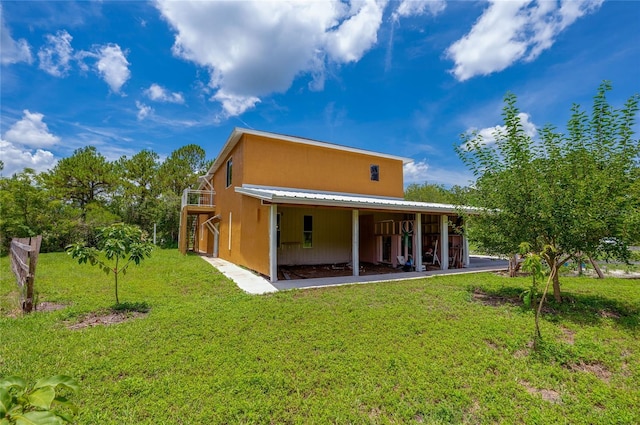 4666 Fir Rd, New Smyrna Beach, FL 32168 - rear view of property featuring a lawn and a metal roof