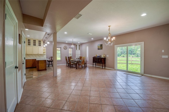4666 Fir Rd, New Smyrna Beach, FL 32168 - living room with a chandelier, recessed lighting, plenty of natural light, and light tile patterned flooring