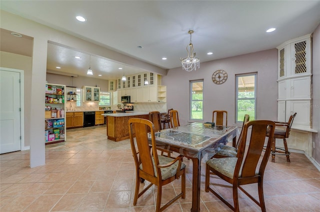 4666 Fir Rd, New Smyrna Beach, FL 32168 - dining space with recessed lighting, light tile patterned floors, and a chandelier