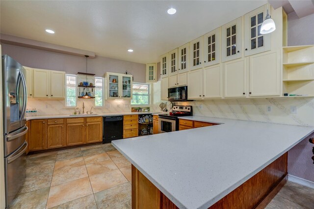 4666 Fir Rd, New Smyrna Beach, FL 32168 - kitchen featuring black appliances, a peninsula, backsplash, recessed lighting, and pendant lighting