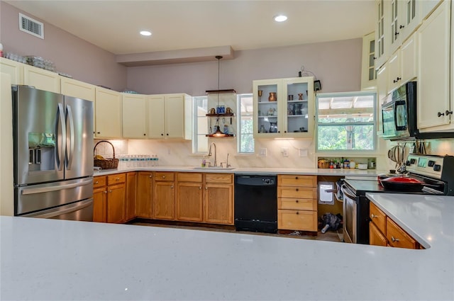4666 Fir Rd, New Smyrna Beach, FL 32168 - kitchen featuring black appliances, backsplash, light countertops, glass insert cabinets, and recessed lighting