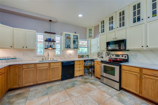 4666 Fir Rd, New Smyrna Beach, FL 32168 - kitchen with black appliances, tasteful backsplash, light countertops, pendant lighting, and recessed lighting