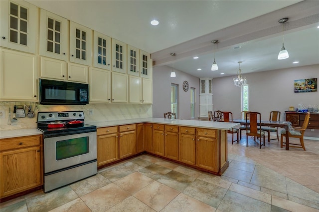 4666 Fir Rd, New Smyrna Beach, FL 32168 - kitchen with black microwave, stainless steel range with electric cooktop, backsplash, light countertops, and recessed lighting
