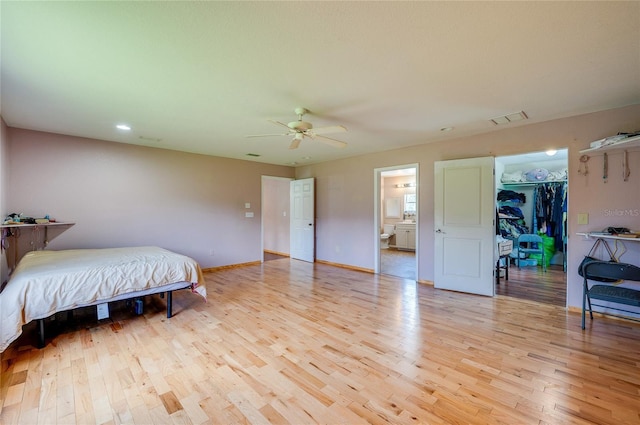 4666 Fir Rd, New Smyrna Beach, FL 32168 - bedroom featuring light wood-type flooring, a walk in closet, a ceiling fan, and recessed lighting