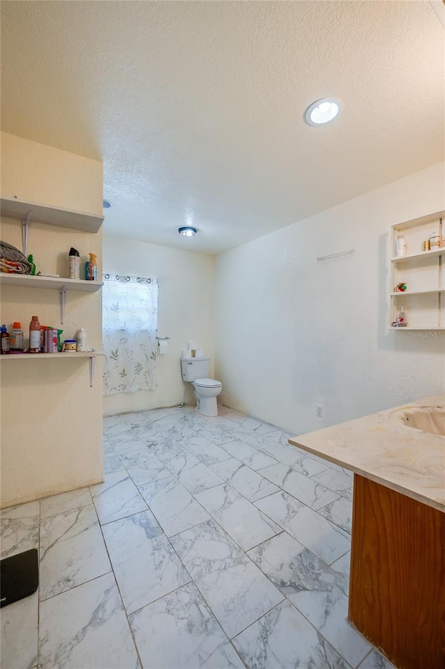 4666 Fir Rd, New Smyrna Beach, FL 32168 - bathroom featuring a textured ceiling, marble finish flooring, vanity, and recessed lighting