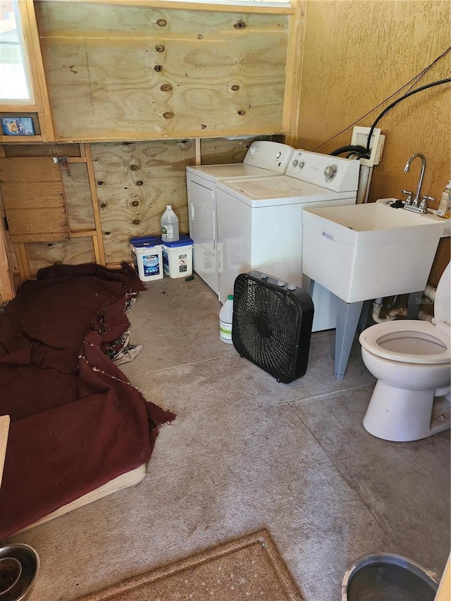 4666 Fir Rd, New Smyrna Beach, FL 32168 - bathroom with washing machine and dryer and toilet