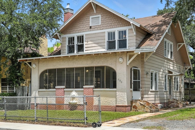 200 N St, Daytona Beach, FL 32114 - view of front of property featuring a sunroom, a chimney, stucco siding, and entry steps