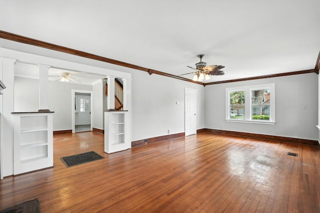 200 N St, Daytona Beach, FL 32114 - unfurnished living room with ceiling fan, plenty of natural light, ornate columns, and crown molding