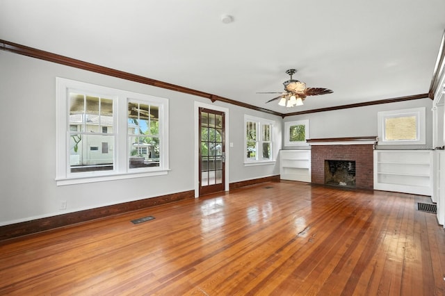 200 N St, Daytona Beach, FL 32114 - unfurnished living room with wood-type flooring, ceiling fan, a fireplace, and ornamental molding