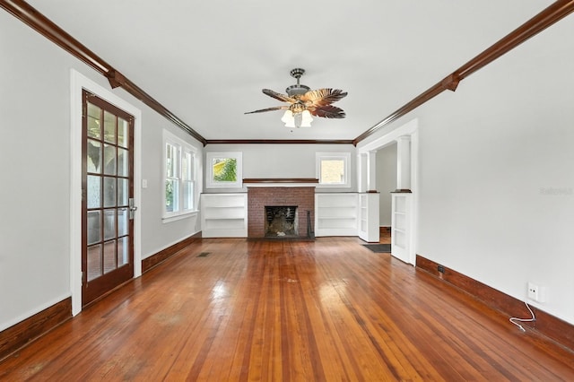 200 N St, Daytona Beach, FL 32114 - unfurnished living room featuring crown molding, hardwood / wood-style flooring, a fireplace, and a ceiling fan