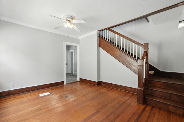 200 N St, Daytona Beach, FL 32114 - unfurnished living room featuring stairway, hardwood / wood-style flooring, ceiling fan, and crown molding