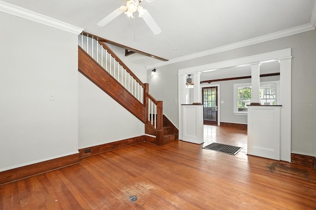 200 N St, Daytona Beach, FL 32114 - unfurnished living room with hardwood / wood-style flooring, a ceiling fan, decorative columns, ornamental molding, and stairway