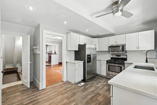 200 N St, Daytona Beach, FL 32114 - kitchen with stainless steel appliances, ceiling fan, decorative backsplash, light wood-type flooring, and recessed lighting
