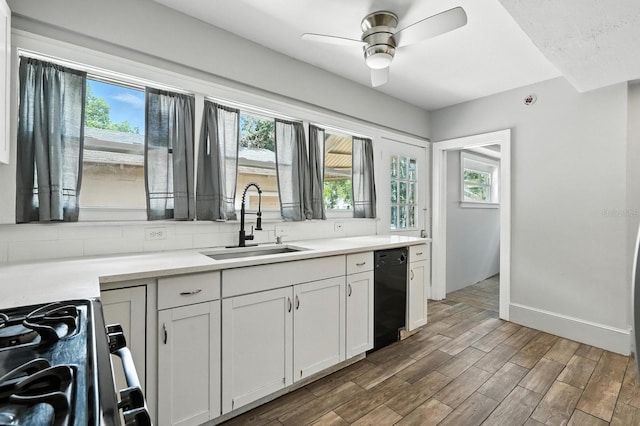200 N St, Daytona Beach, FL 32114 - kitchen with dishwasher, range with gas cooktop, healthy amount of natural light, and light countertops