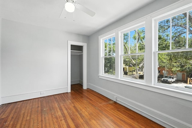 200 N St, Daytona Beach, FL 32114 - unfurnished bedroom featuring multiple windows, a closet, hardwood / wood-style flooring, and a ceiling fan