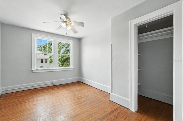 200 N St, Daytona Beach, FL 32114 - unfurnished bedroom featuring wood-type flooring, a walk in closet, and ceiling fan