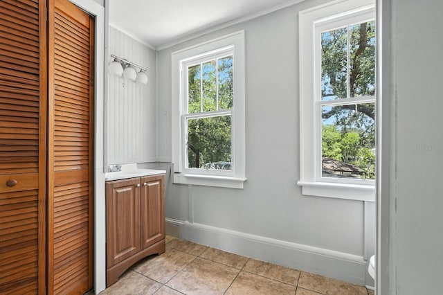 200 N St, Daytona Beach, FL 32114 - bathroom featuring a closet, tile patterned floors, crown molding, and vanity