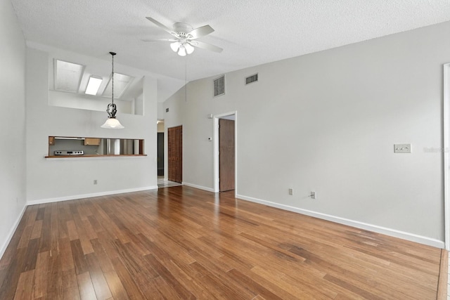 1512 Heritage Ln, Daytona Beach, FL 32117 - unfurnished living room with ceiling fan, wood finished floors, a textured ceiling, and high vaulted ceiling