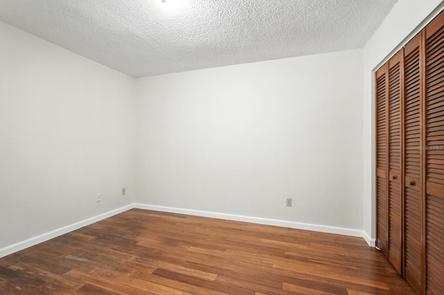 1512 Heritage Ln, Daytona Beach, FL 32117 - unfurnished bedroom featuring a closet, wood finished floors, and a textured ceiling
