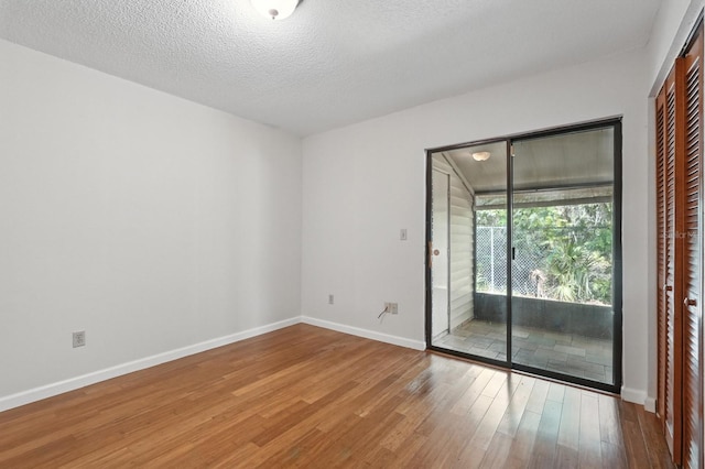 1512 Heritage Ln, Daytona Beach, FL 32117 - empty room with wood finished floors and a textured ceiling