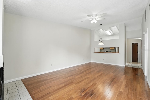1512 Heritage Ln, Daytona Beach, FL 32117 - unfurnished living room featuring a ceiling fan, a textured ceiling, and wood finished floors