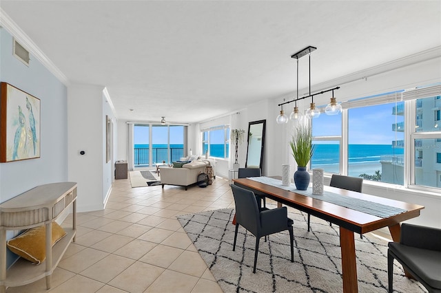 3315 S Atlantic Ave Unit 408, Daytona Beach Shores, FL 32118 - dining area with light tile patterned floors, a water view, and crown molding