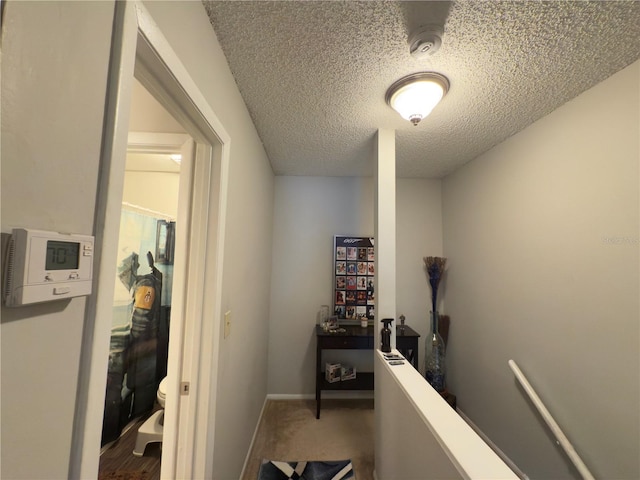 4155 S Semoran Blvd Unit 8, Orlando, FL 32822 - hallway featuring a textured ceiling and baseboards