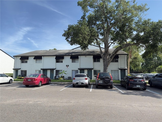 4155 S Semoran Blvd Unit 8, Orlando, FL 32822 - traditional-style house featuring uncovered parking, stucco siding, and a shingled roof