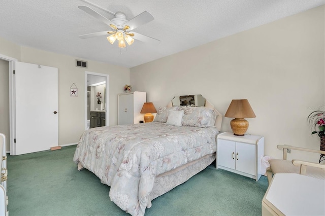 bedroom with dark colored carpet, connected bathroom, ceiling fan, and a textured ceiling