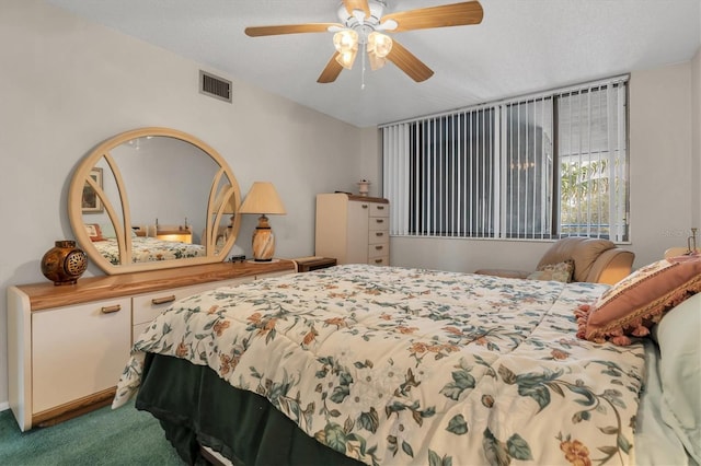 bedroom featuring a textured ceiling, ceiling fan, and carpet floors